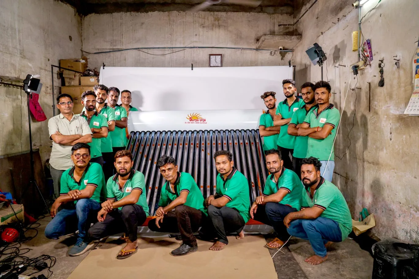 The Surya Urja team with a solar water heater collector at the Anand workshop